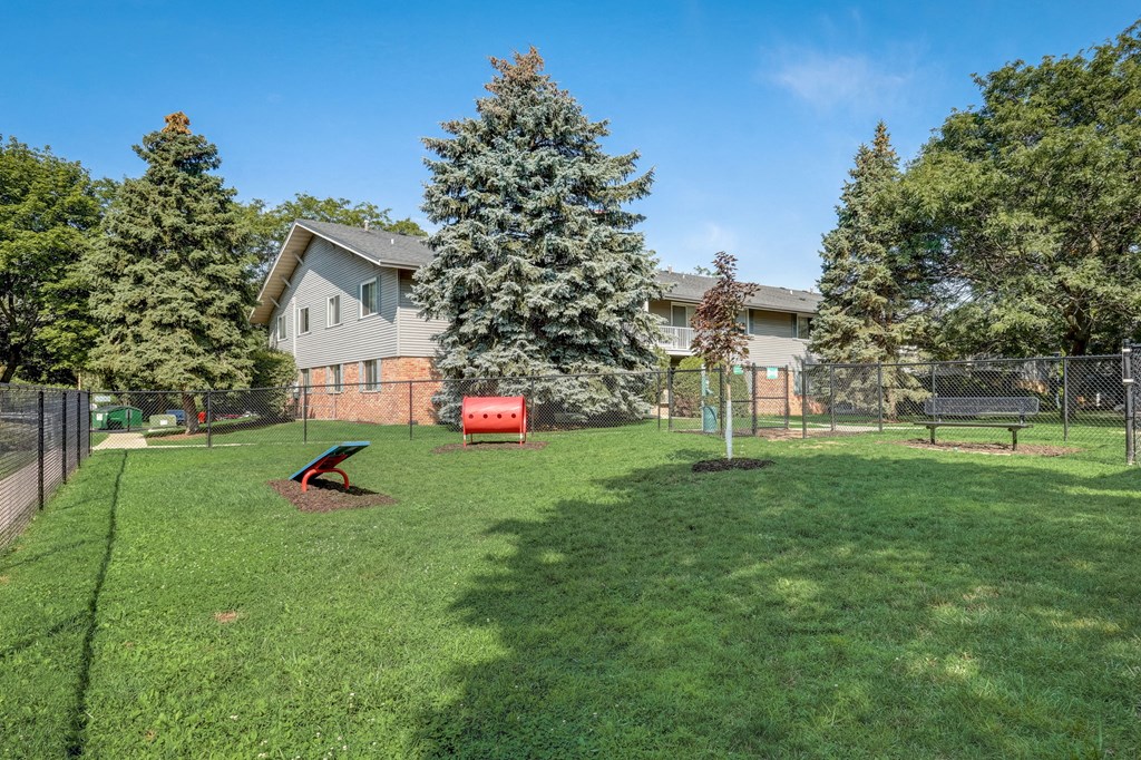 the backyard of a house with a dog park and a fence