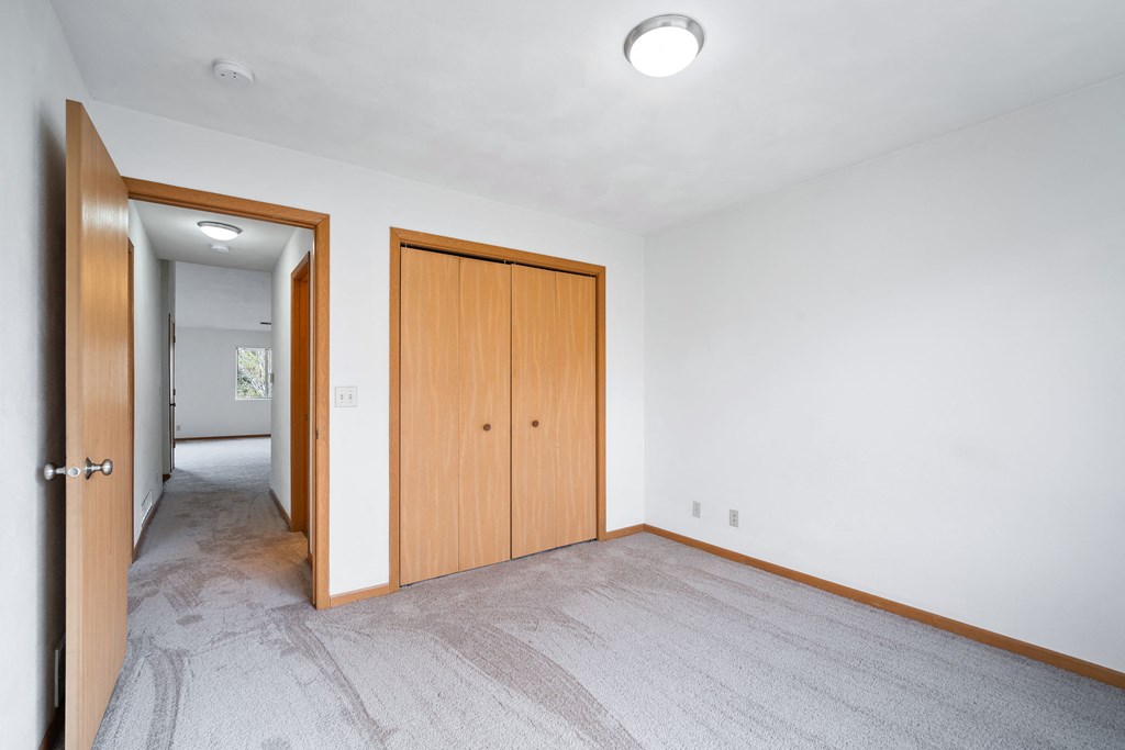 a living room with a door to a bedroom and a hallway