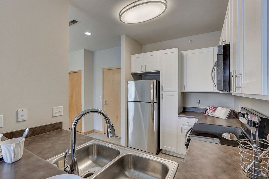 a kitchen with stainless steel appliances and a sink
