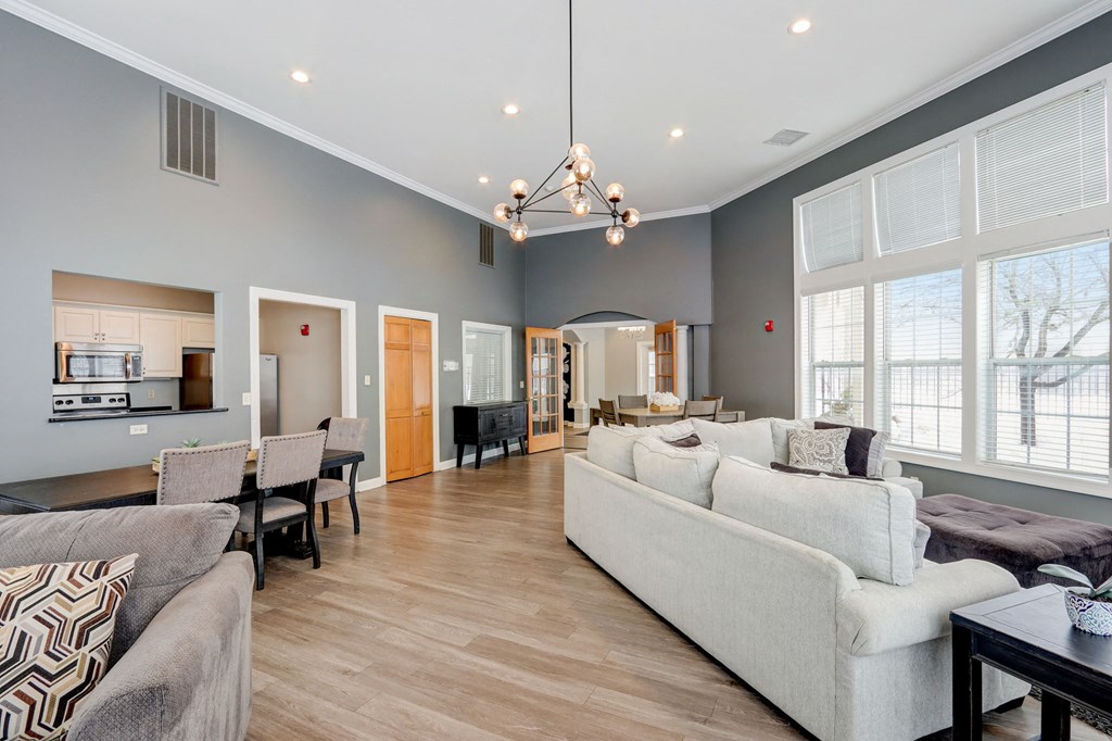 a living room with couches and chairs and a dining room table