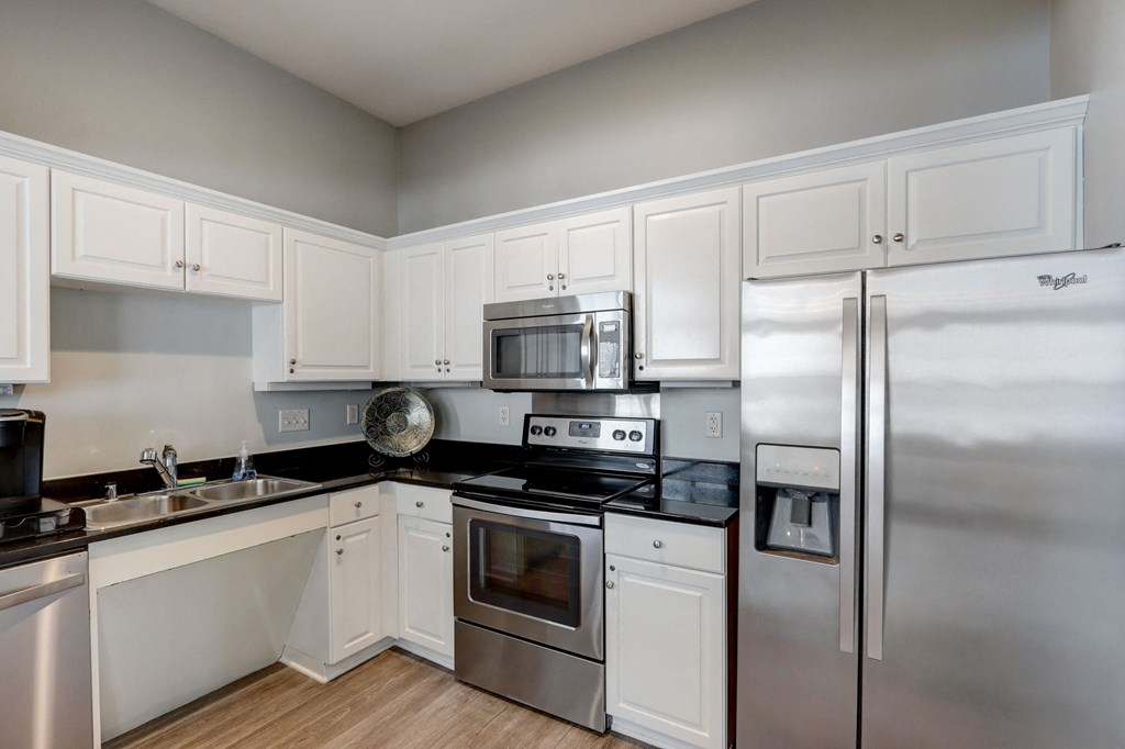 a kitchen with stainless steel appliances and white cabinets