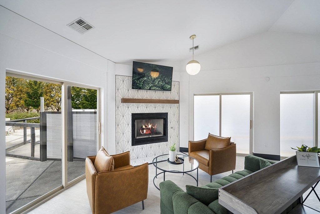 a living room with a fireplace and a table and chairs