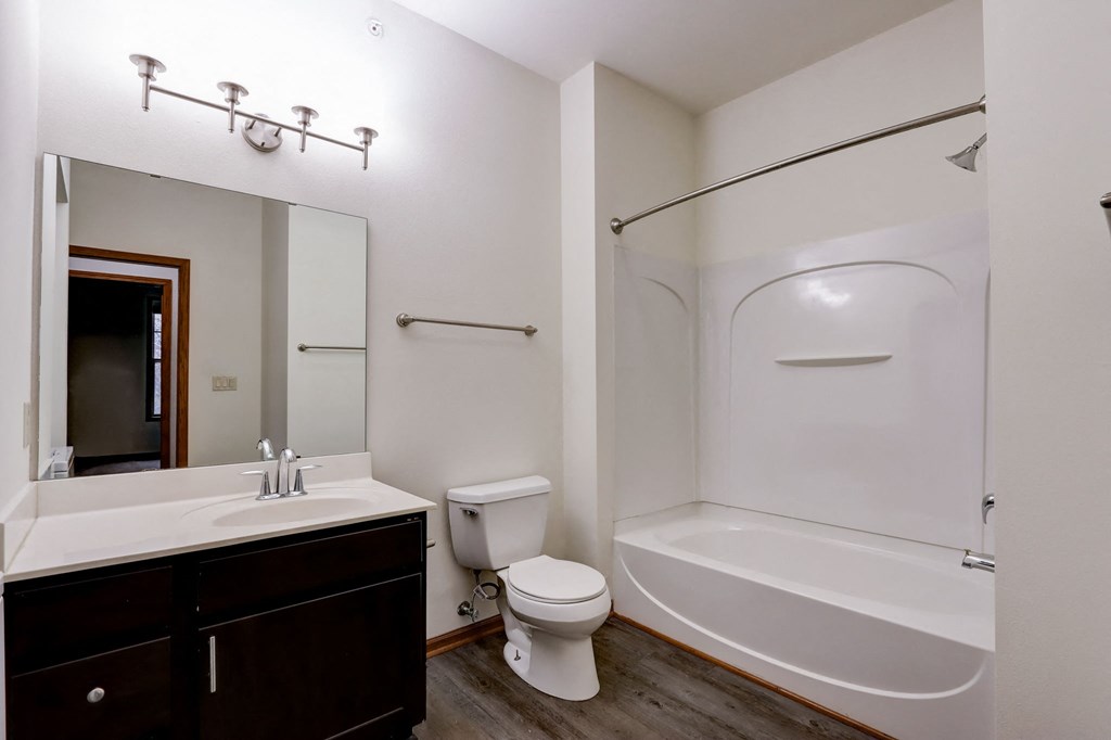 a bathroom with a shower toilet and sink and a mirror