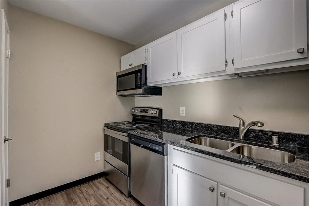 a kitchen with stainless steel appliances and white cabinets