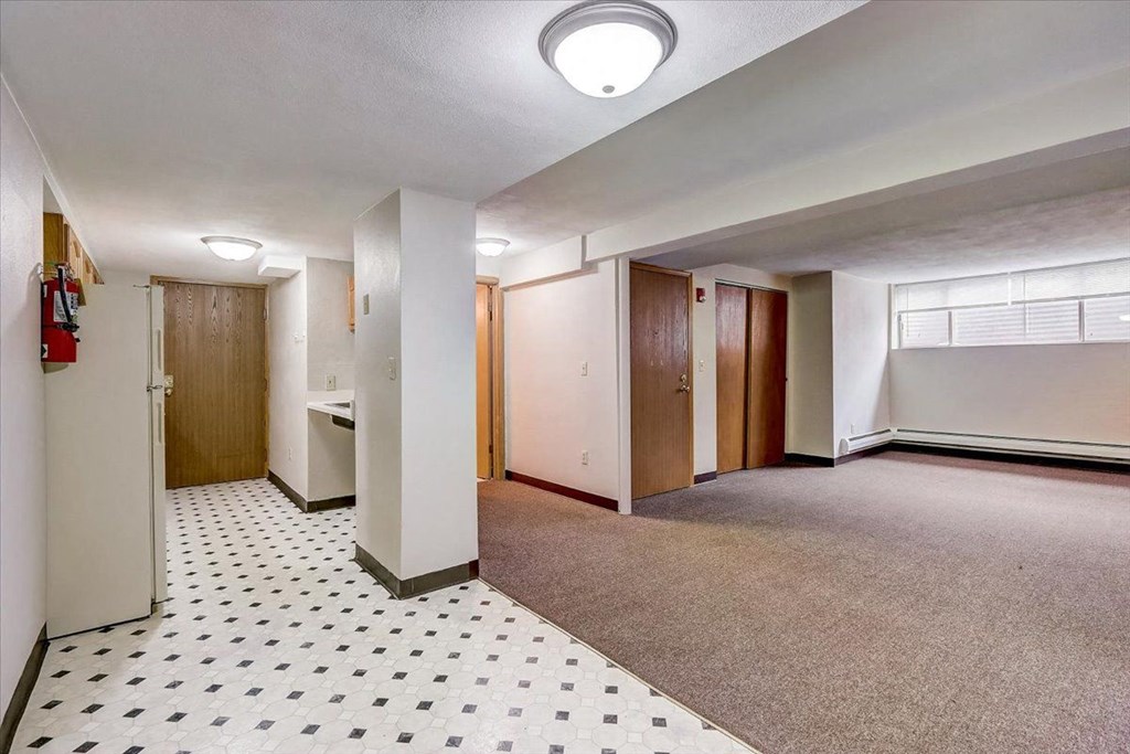 an empty room with a hallway and a door
