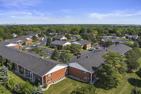 A large building complex with a parking lot in front.