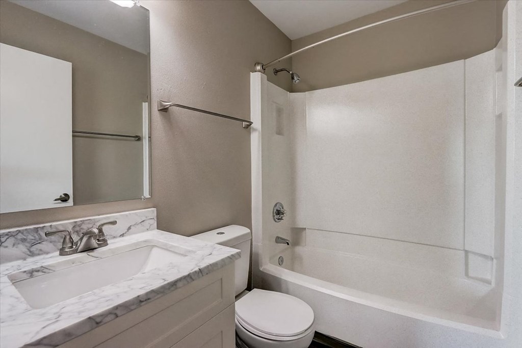a bathroom with a sink toilet and a shower