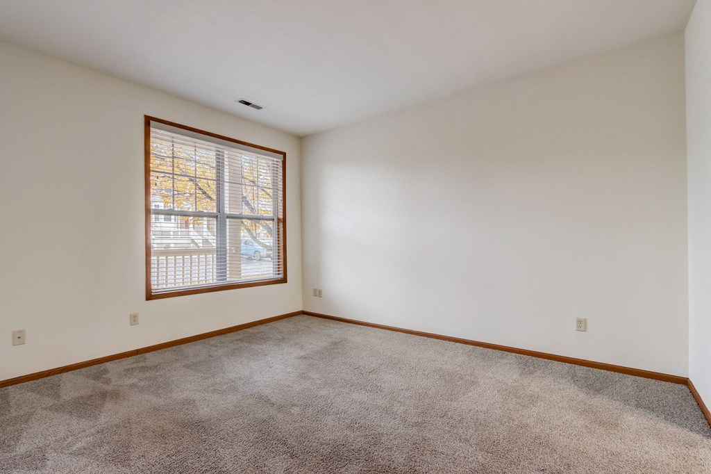 a living room with carpet and a window