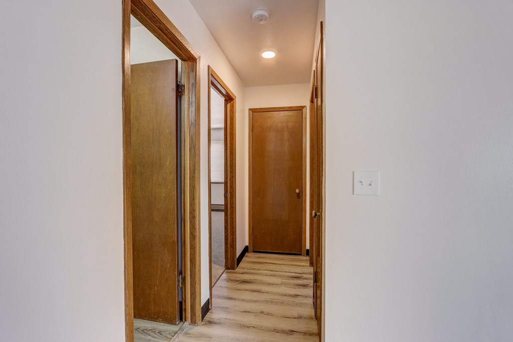 a look down the hall from the living room to the bedrooms
