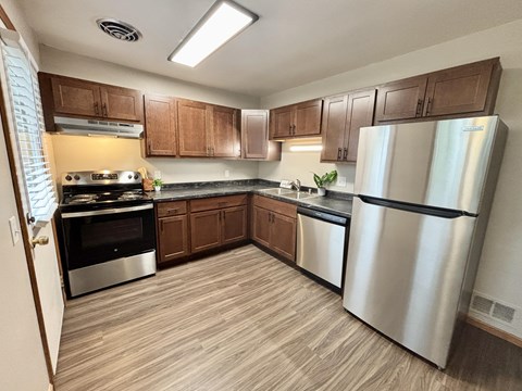 A kitchen with wooden cabinets and stainless steel appliances.