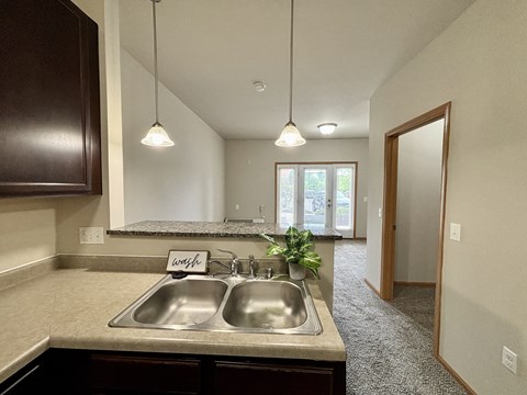 A kitchen with a sink and a sign that says "worth".