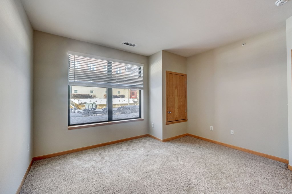 an empty living room with a large window