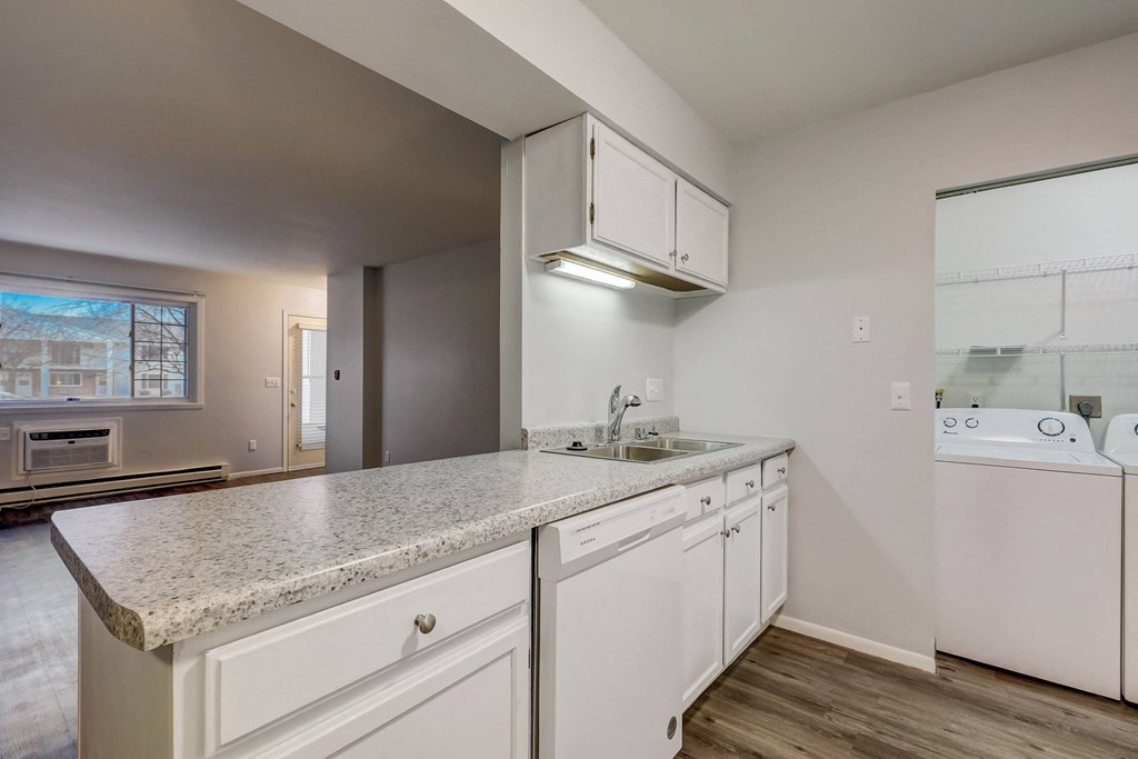 a kitchen with white cabinetry and granite countertops