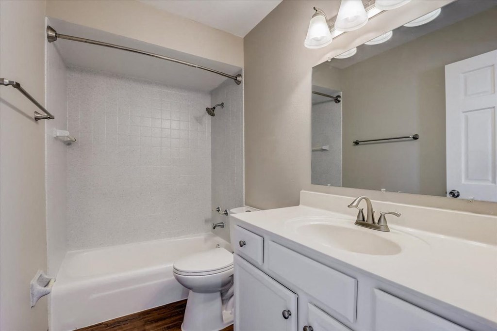 a bathroom with a sink toilet and a bath tub