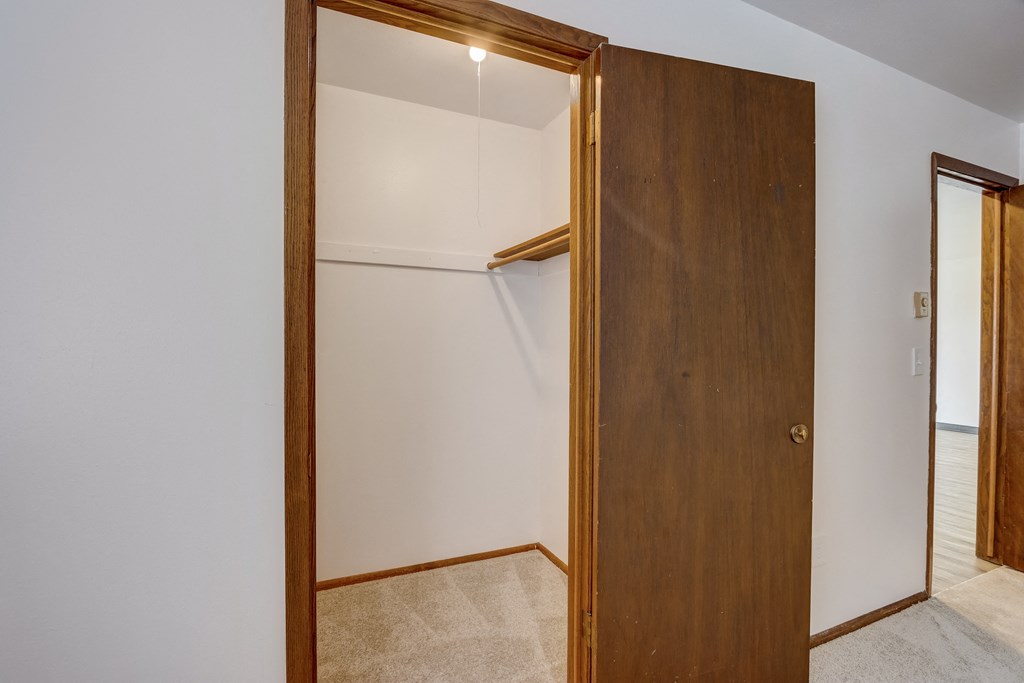 a walk in closet in a bedroom