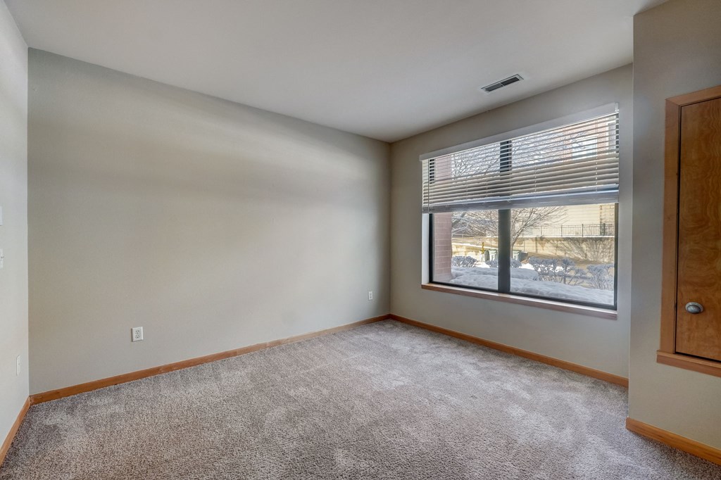 an empty living room with a large window
