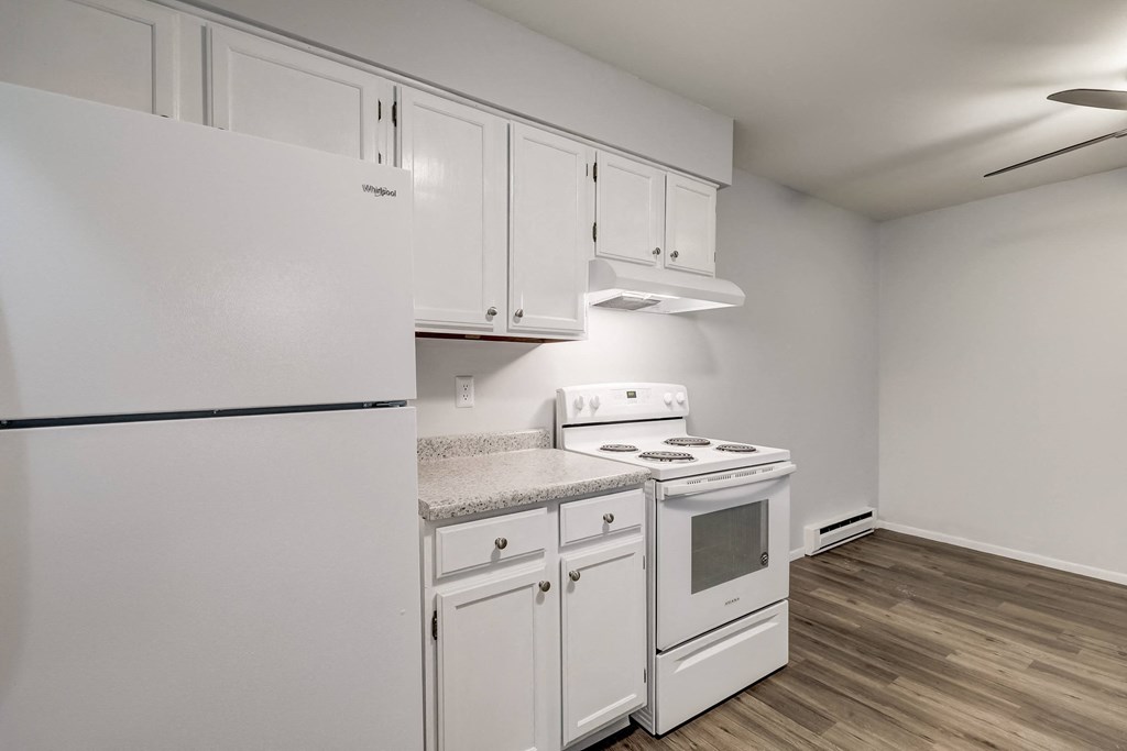 a kitchen with white appliances and white cabinets