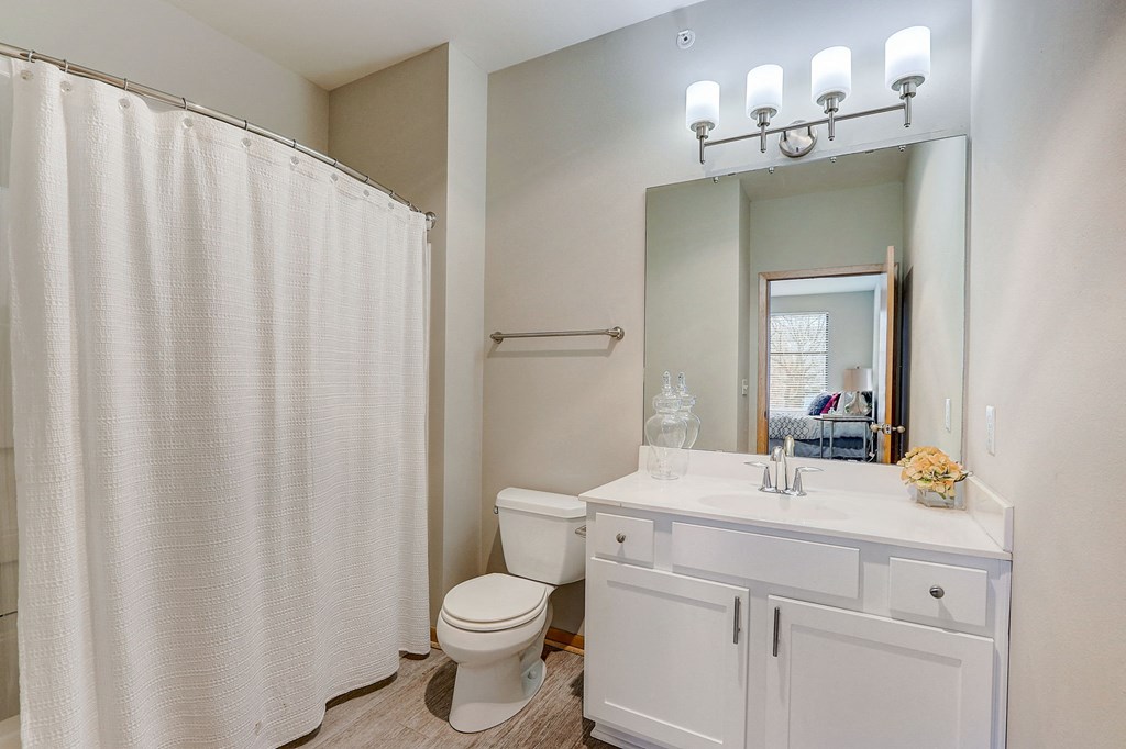 a bathroom with a shower and a sink and a toilet