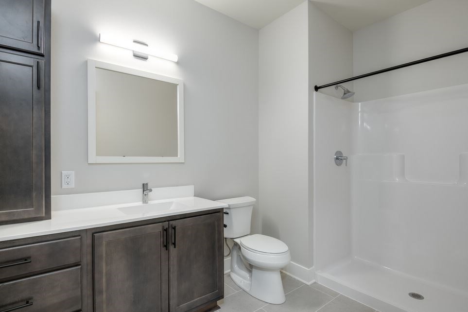 A bathroom with a white toilet and a white sink.