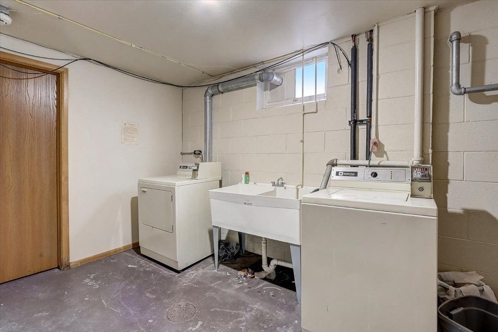 a laundry room with a sink and a washing machine