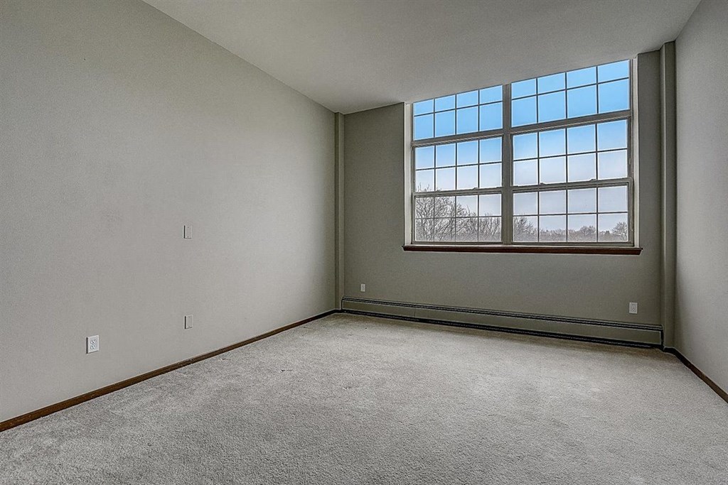 an empty living room with a large window