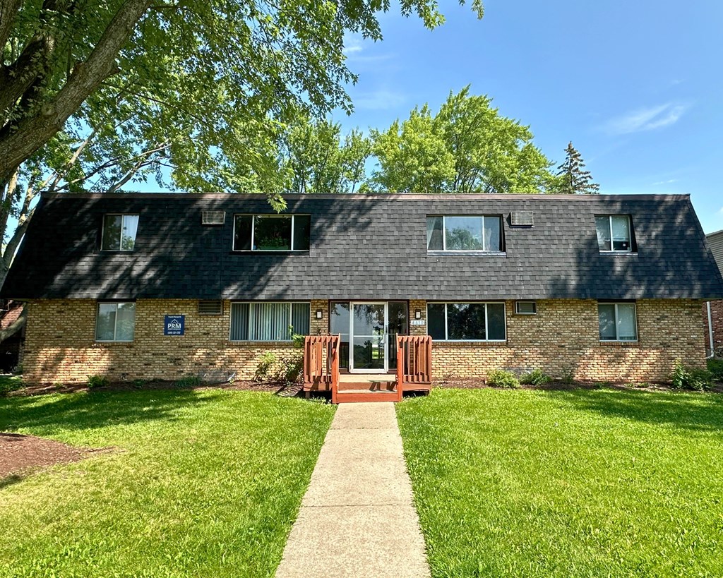 A house with a brown door and a porch.