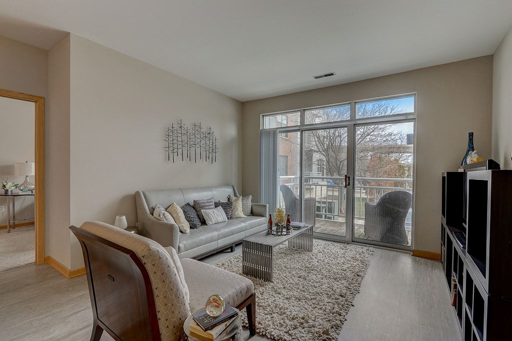 an aerial view of a living room with a staircase and a large window