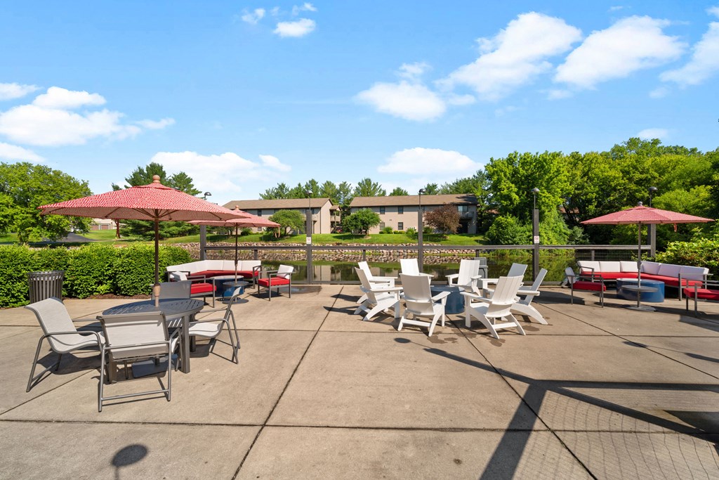 a patio with tables and chairs and umbrellas