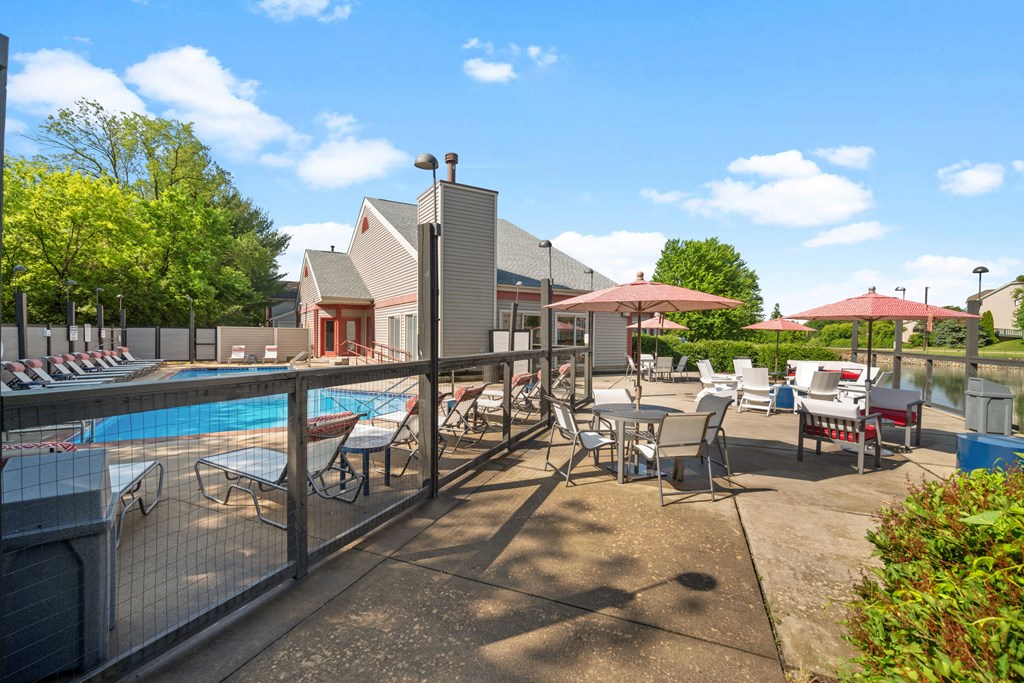 a swimming pool with tables and chairs at a resort