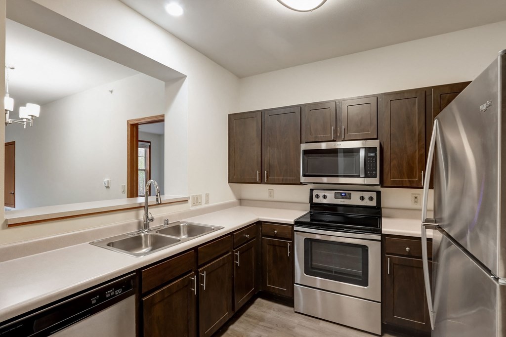 a kitchen with a stove and a refrigerator