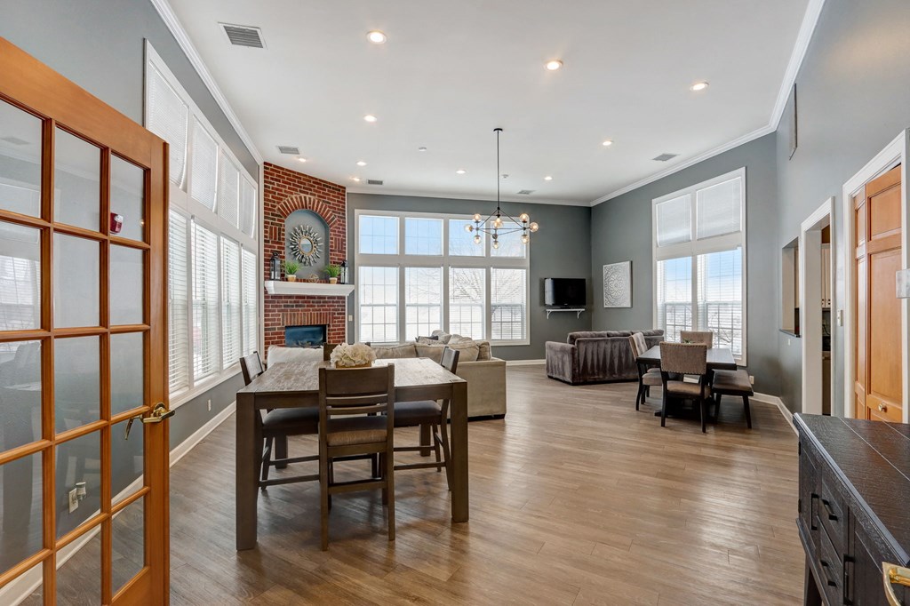 a dining room and living room with a table and chairs