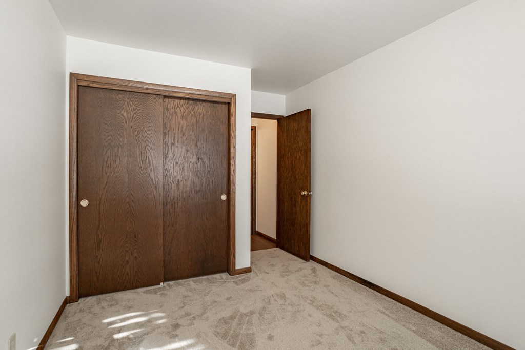 a room with two doors and a carpeted floor