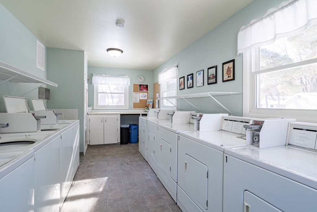 a laundry room with white appliances and white counter tops