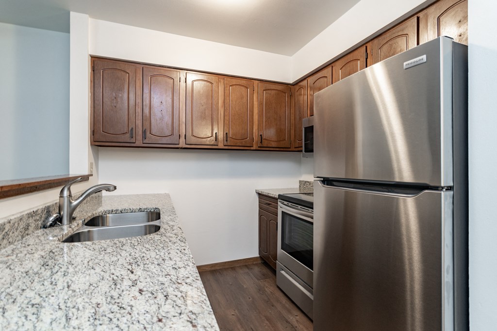 a kitchen with stainless steel appliances and granite counter tops