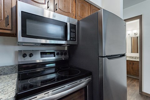 an updated kitchen with stainless steel appliances and a microwave