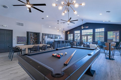 a pool table and bar in a resident clubhouse