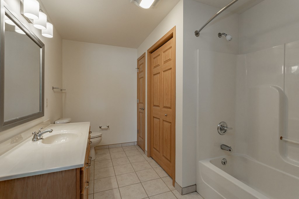 a bathroom with a sink and a shower and a toilet