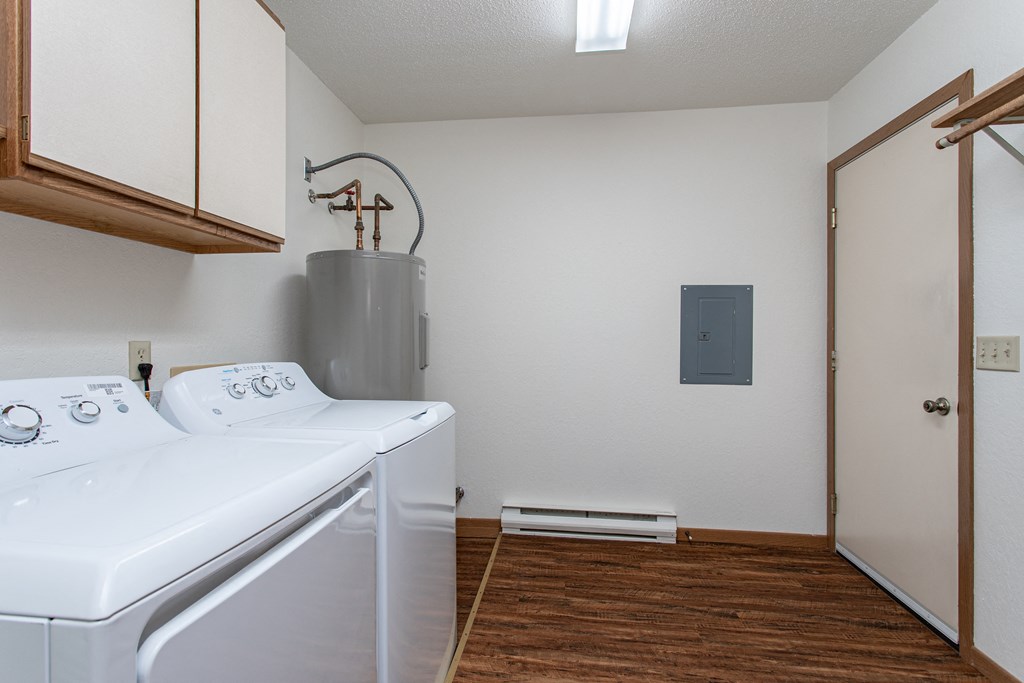 the laundry room has a washer and dryer and a door to the closet