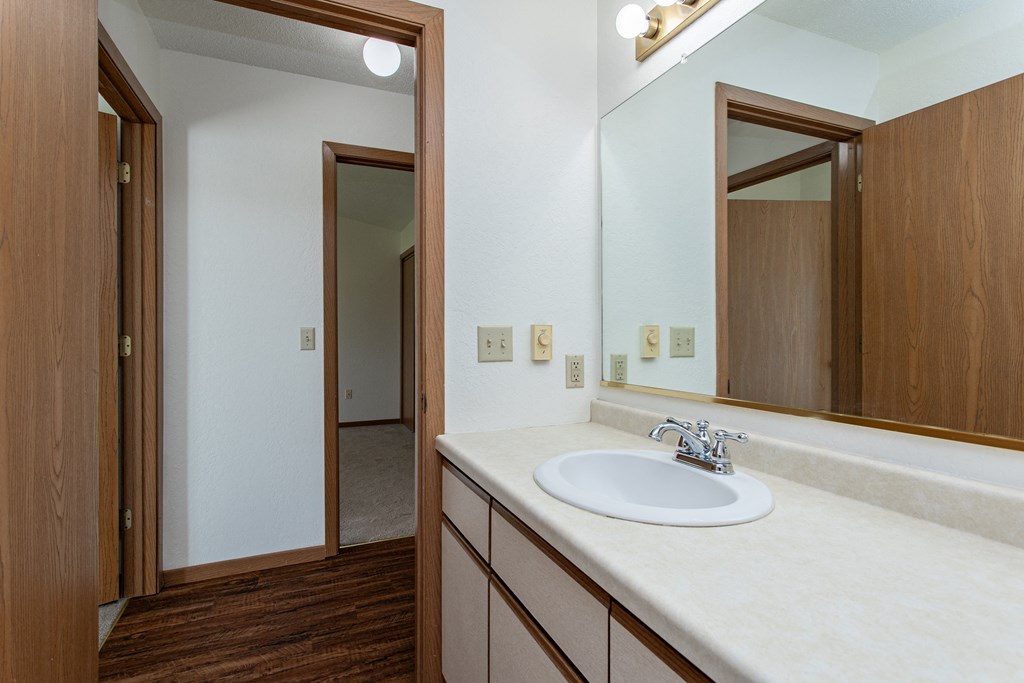 a bathroom with a sink and a mirror in a house