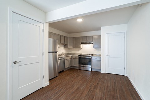 a renovated kitchen with stainless steel appliances and wood flooring