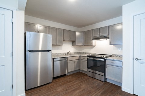 a kitchen with stainless steel appliances and white cabinets