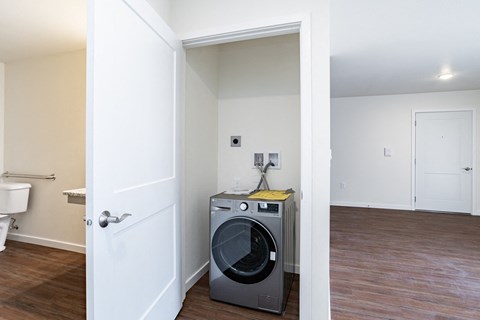 an empty room with a washing machine and a dryer in it