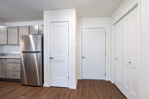 a renovated kitchen with stainless steel appliances and white doors
