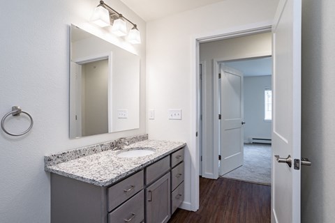 an empty bathroom with a sink and a mirror