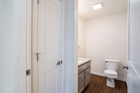 a bathroom with a toilet and a sink and a white door