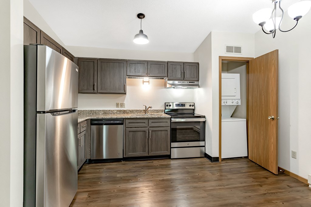 a kitchen with stainless steel appliances and wooden cabinets