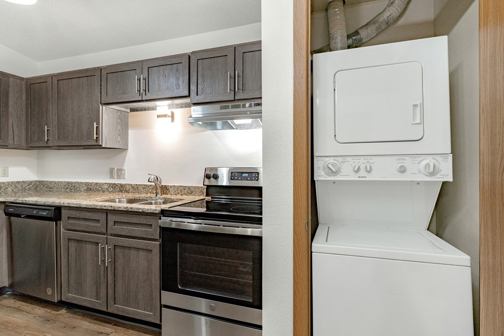a view of a kitchen with a stove refrigerator and sink