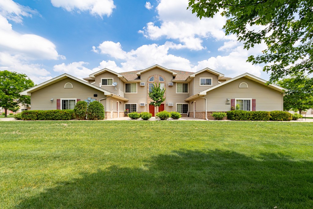 a home with a large lawn in front of it
