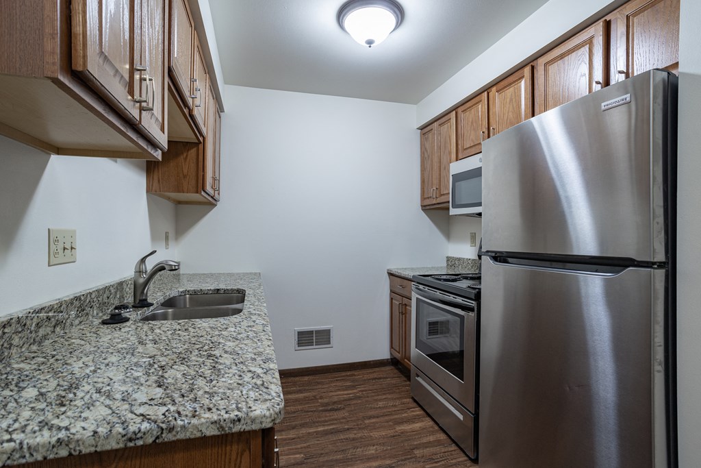 a kitchen with stainless steel appliances and granite counter top and