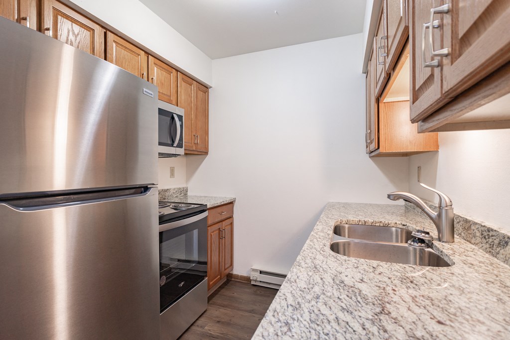 a kitchen with stainless steel appliances and granite counter tops